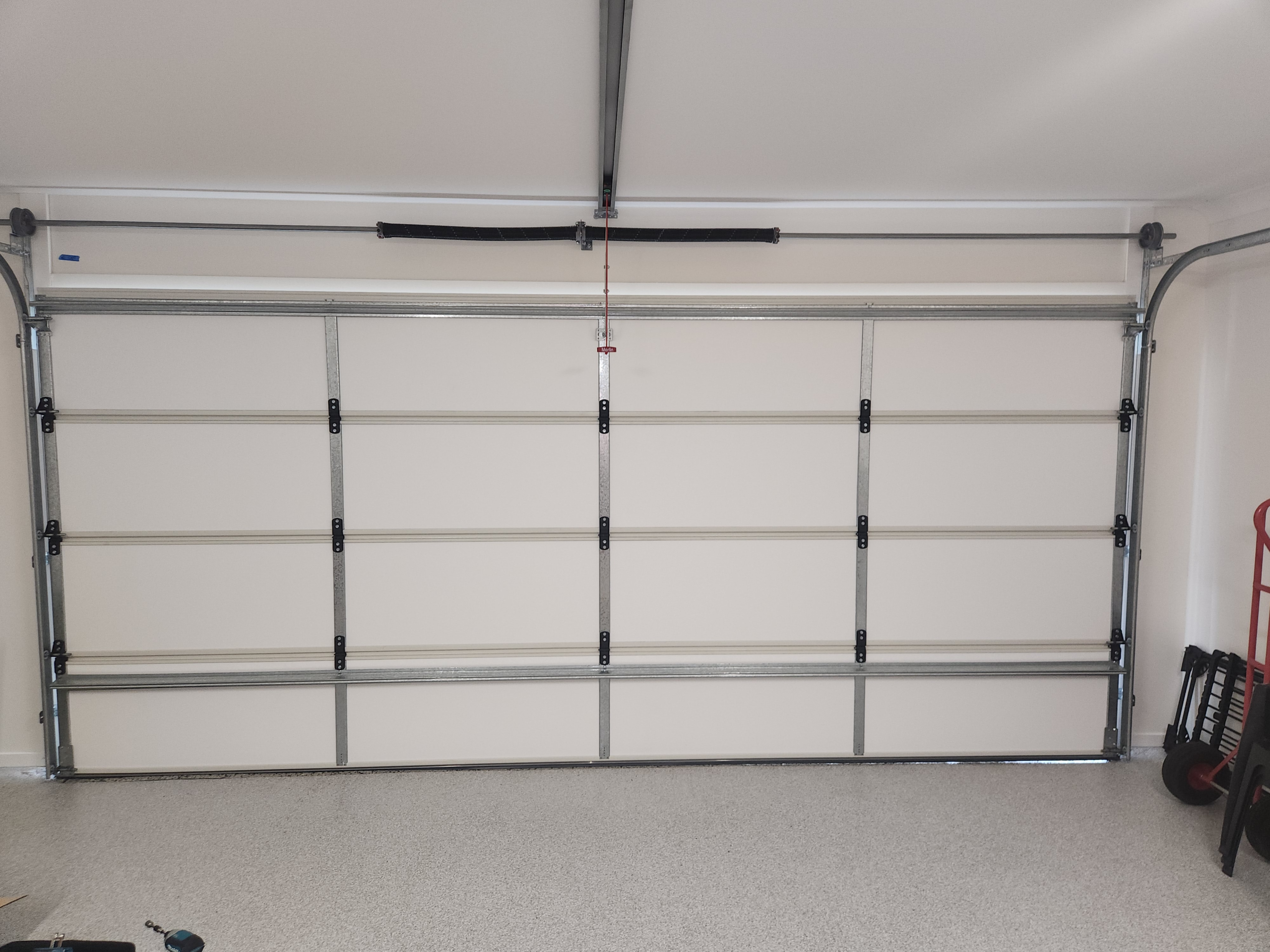 After_Thermadoor_Insualtion Garage door technician carrying out routine maintenance for homes in Brisbane, Logan, Ipswich, Redlands, Moreton Bay and the Gold Coast
