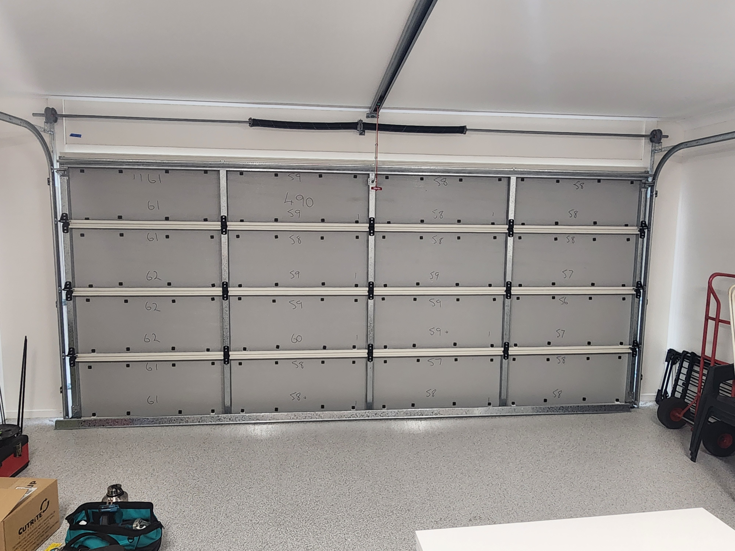 #Before_Thermadoor_insulation Garage door technician carrying out routine maintenance for homes in Brisbane, Logan, Ipswich, Redlands, Moreton Bay and the Gold Coast